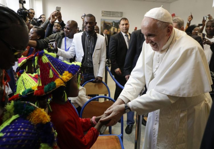 Pope Francis meets migrants at the diocesan Caritas center in Rabat, Morocco, Saturday. Francis's weekend trip to Morocco aims to highlight the North African nation's tradition of Christian-Muslim ties while also letting him show solidarity with migrants at Europe's door.