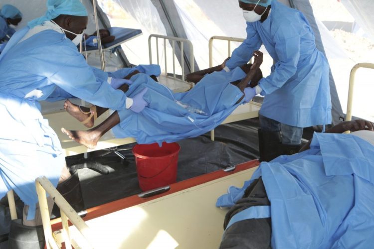 A woman diagnosed with cholera is placed on a stretcher at a treatment centre in Beira, Mozambique on Saturday. Doctors Without Borders has said it is seeing some 200 likely cholera cases per day in the city.