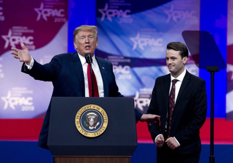 In this March 2, 2019 photo, President Donald Trump invites to the podium, Hayden Williams, a field representative of the Leadership Institute, who was assaulted at Berkeley campus, at the Conservative Political Action Conference, CPAC 2019, in Oxon Hill, Md. 