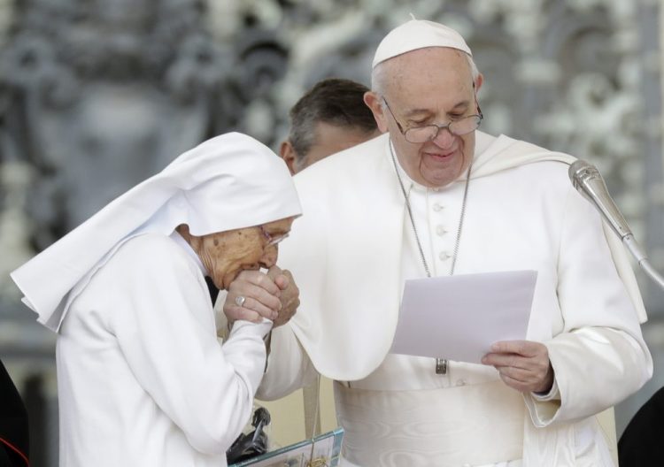 85-year-old sister Maria Concetta Esu kisses the hand of Pope Francis during his weekly general audience in St. Peter's Square on Wednesday.