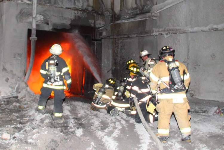 Fire crews work to extinguish flames at a building at Dragon Products on Wednesday night.