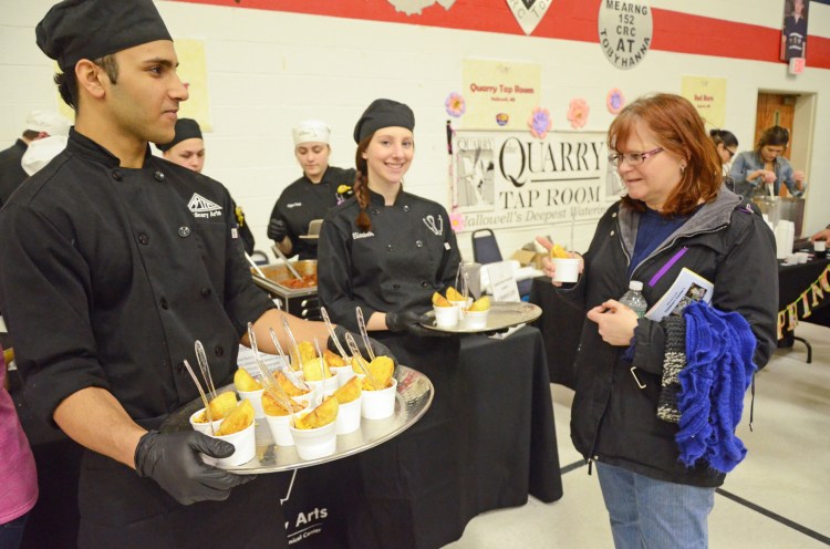 “Students from Capital Area Technical Center Hussein Al Braihi, of Augusta, and Elizabeth Young, of China, serve their chili, which won the “Best Chili Award.”