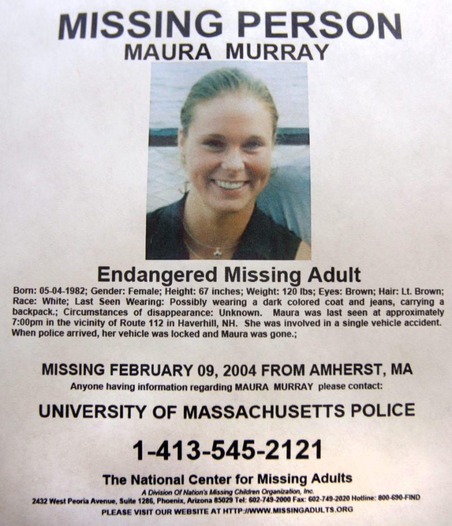 This Feb. 4, 2014 photo shows a missing person poster of Maura Murray that hangs in the lobby of the police station in Haverhill, N.H. Authorities are in an area of the northern New Hampshire town on Wednesday, April 3, 2019, related to an ongoing investigation into her disappearance in 2004. 