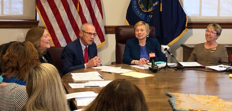 Gov. Janet Mills, center, listens as Gordon Smith, director of opioid response for the state, addresses the first gathering of the governor’s Prevention and Recovery Cabinet on Wednesday at the State House. 
