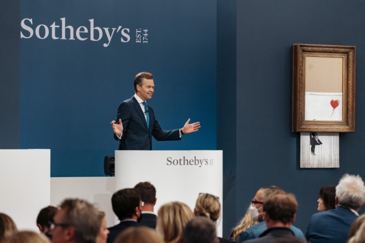 The auction for Banksy's "Love is the Bin" takes place in London, Thursday.
