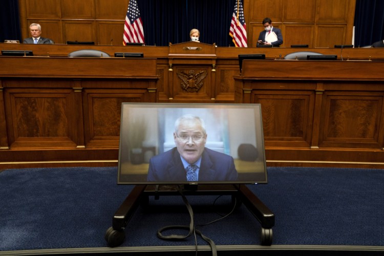 Darren Woods, CEO of ExxonMobil, testifies via video conference during a House Committee on Oversight and Reform hearing on the role of fossil fuel companies in climate change, on Thursday on Capitol Hill in Washington. 