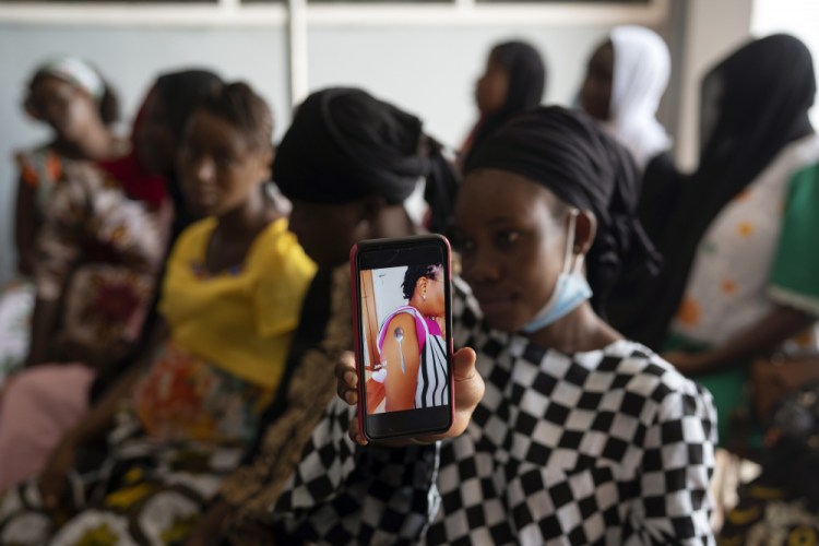 Oumie Nyassi shows a video circulating on the internet Sept. 23 and that had been confirmed as fake news of a woman claiming she was magnetized after receiving the COVID-19 vaccine, in a doctor's office at Serrekunda, Gambia hospital. Last spring, as false claims about vaccine safety threatened to undermine the world's response to COVID-19, researchers at Facebook wrote that they could reduce vaccine misinformation by tweaking how vaccine posts show up on users' newsfeeds, or by turning off comments entirely. Yet despite internal documents showing these changes worked, Facebook was slow to take action. 

