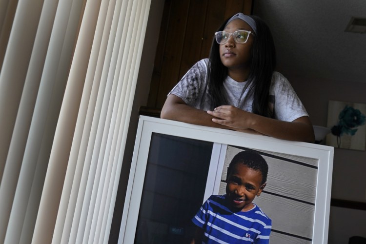 Charron Powell stands with a photo of her son, LeGend Talieferro, at her home in Raytown, Mo., on Oct. 3. LeGend was 4 years old when he was fatally shot June 29, 2020, while he was sleeping in an apartment, staying with his father. 

