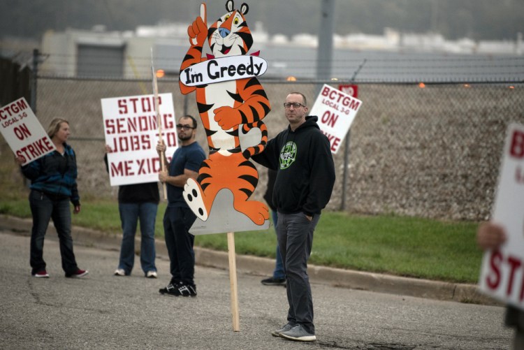 Travis Huffman joins other BCTGM Local 3G union members in a strike against Kellogg Co. on Tuesday in Battle Creek, Mich. 

