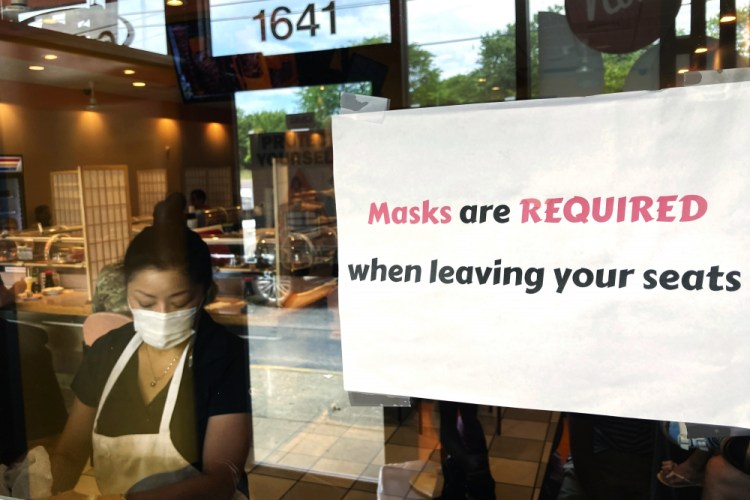 A sign requiring masks is displayed at a restaurant in Rolling Meadows, Ill.

Nam Y. Huh/Associated Press, file