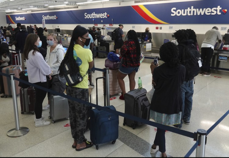 Passengers wait in line at the Southwest Airlines ticket counter at Fort Lauderdale Hollywood International Airport, on Monday.  