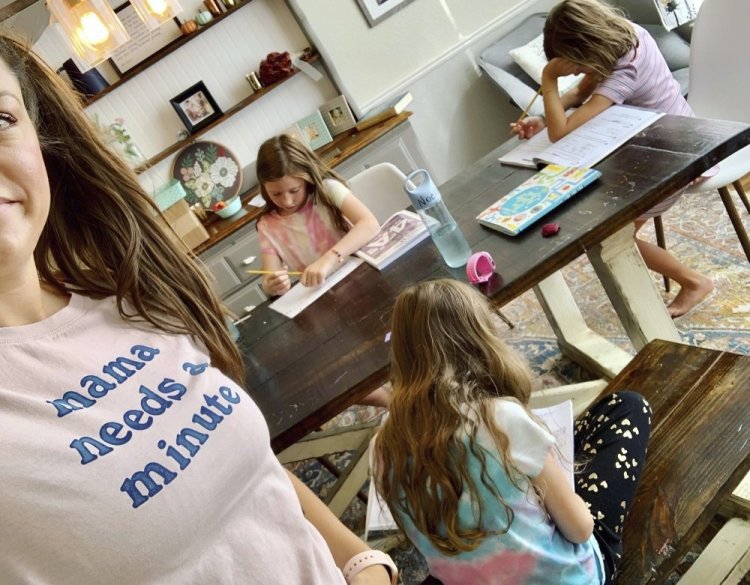 Amber Cessac takes a selfie as her daughters do their homework at their home in Georgetown, Texas, on Sept. 9. A year and a half in, there is still the exhaustion of worrying about exposure to COVID-19 itself, and the policies at schools and day cares. The spread of the more infectious delta variant, particularly among people who refuse vaccinations, has caused a big increase in infections in children. But there’s also COVID exposures and illnesses – and even minor colds – at schools and day cares that mean children get sent home, forcing parents to scramble for child care.