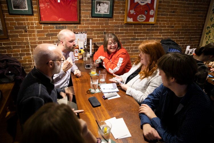 Team members talk over their answers during trivia night at Gritty McDuff's in February of 2020, pre-pandemic.