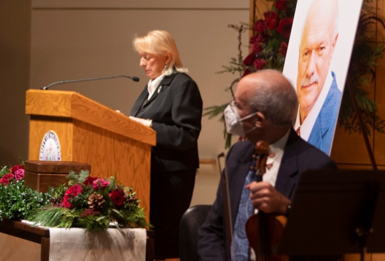 A portrait of Maine business icon David Flanagan is displayed as Gov. Janet Mills speaks at a memorial service in his honor at USM’s Hannaford Hall in Portland on Saturday.
