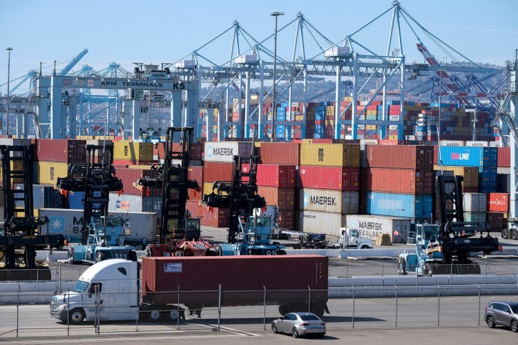 FILE - Cargo containers sit stacked at the Port of Los Angeles, Wednesday, Oct. 20, 2021 in San Pedro, Calif. The Los Angeles-Long Beach port complex will begin fining shipping companies if they let cargo containers stack up as the nation's busiest twin harbors deal with an unprecedented backlog of vessels. The Los Angeles and Long Beach harbor commissions voted Friday, Oct. 29, 2021 to implement a 90-day “container excess dwell fee” that sets time limits on how long containers can stay at marine terminals. (AP Photo/Ringo H.W. Chiu, File)