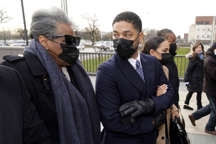 Actor Jussie Smollett looks back at his mother as they arrive with other family members Monday at the Leighton Criminal Courthouse for jury selection at his trial in Chicago. Smollett is accused of lying to police when he reported he was the victim of a racist, anti-gay attack in downtown Chicago nearly three years ago.  

