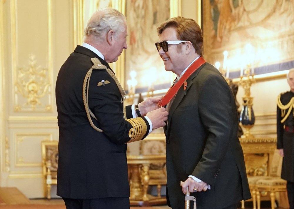 Sir Elton John is made a member of the Order of the Companions of Honour by Prince Charles during an investiture ceremony at Windsor Castle, in Windsor, England, on Wednesday. (Aaron Chown/PA via AP)