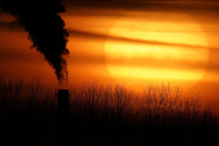 Emissions from a coal-fired power plant are silhouetted against the setting sun Feb. 1 in Kansas City, Mo. 


