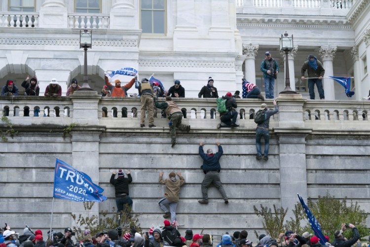 Supporters of then President Trump climb the west wall of the the U.S. Capitol in Washington on Jan. 6. The House committee investigating the Jan. 6 insurrection at the U.S. Capitol has subpoenaed the Proud Boys, Oath Keepers and other groups. 