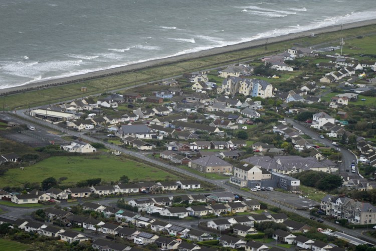 An aerial view of Fairbourne village in Gwynedd in Wales, on Oct. 20. Residents in the small coastal village face being the U.K.'s first "climate refugees." Authorities say that by 2054, it will no longer be sustainable to keep up flood defenses there because of faster sea level rises and more frequent and extreme storms caused by climate change.