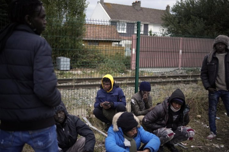 Migrants wait for food distribution at a camp in Calais, northern France, last month. The price to cross the English Channel varies according to the network of smugglers, between 3,000 and 7,000 euros. 