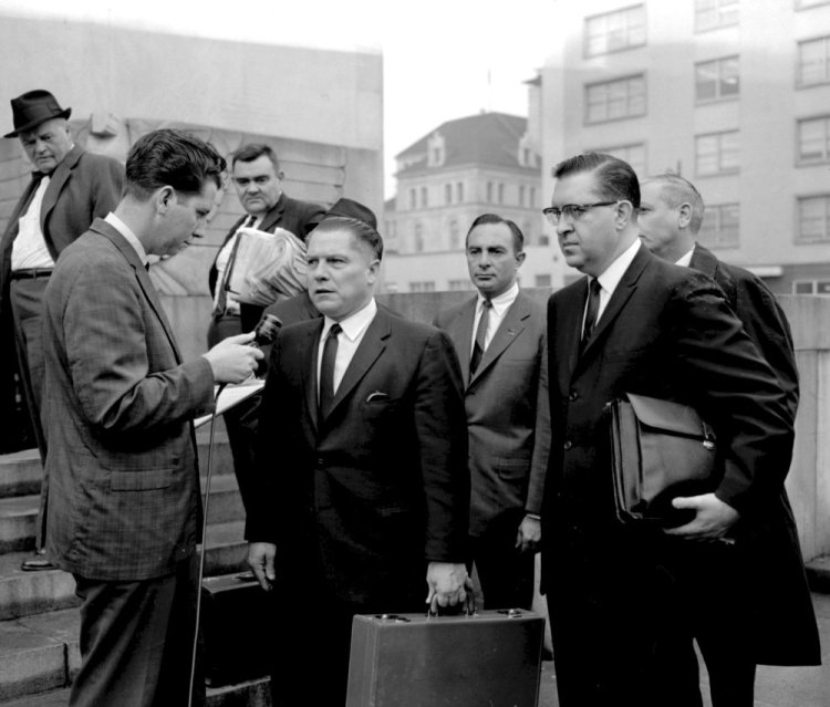 In this 1964 photo, a reporter questions Teamsters President Jimmy Hoffa outside the federal courthouse in Chattanooga, Tenn., during Hoffa's trial that ended in a jury tampering conviction. The decades-long odyssey to find the body of former Teamsters boss Jimmy Hoffa apparently has turned to a former New Jersey landfill below an elevated highway. 