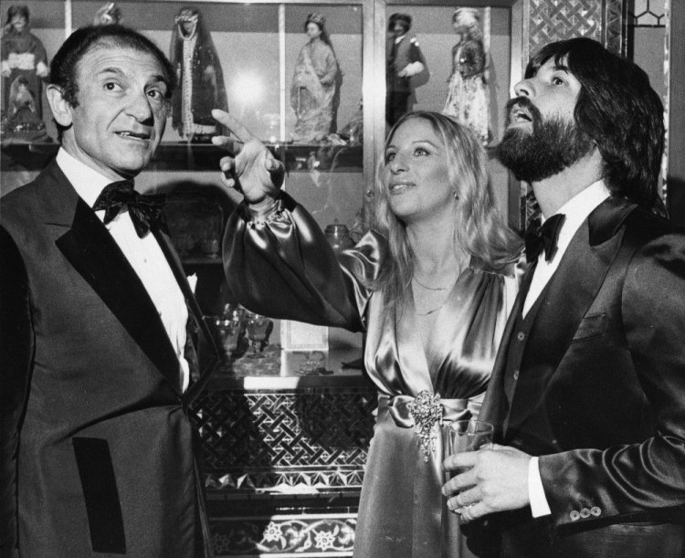 Iran's then-Ambassador Ardeshir Zahedi, left, talks with actress Barbra Streisand and her escort Jon Peters as they admire the Iranian Embassy on March 8, 1975 during a reception in Washington, D.C.
