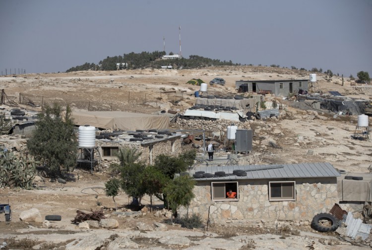 The Israeli settlement of Ma'on, in the background and overlooks the the West Bank Palestinian Bedouin village of al-Mufagara, near Hebron, Sept. 30. On Sunday, Nov. 1, 2021, Israel authorized some 1,300 Palestinian homes in the occupied West Bank days after advancing plans to build more than 3,000 housing units for Jewish settlers. 