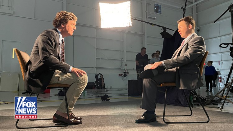 Kyle Rittenhouse, right, sits for an interview with Fox News host Tucker Carlson. Rittenhouse was acquitted on charges stemming from killing two men and wounding another during the unrest that followed the shooting of a Black man by a white police officer in Kenosha, Wis. 