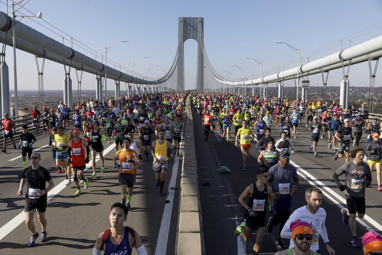 Runners make their way across the Verrazzano-Narrows Bridge during the start of the New York City Marathon in 2019.