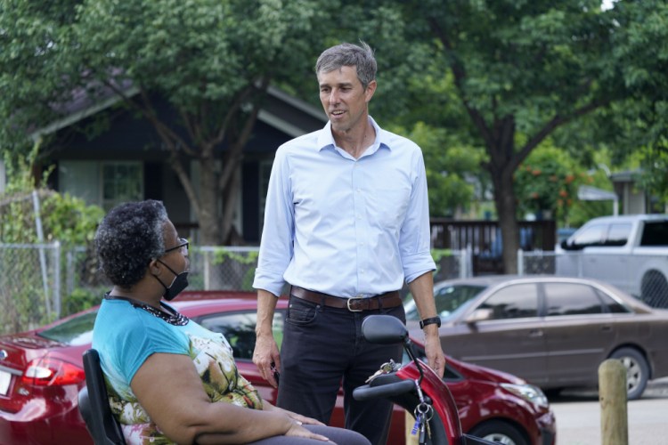 Beto O'Rourke, right, speaks with Stephanie Hanson before a canvassing drive by the Texas Organizing Project in West Dallas Wednesday, June 9, 2021. 