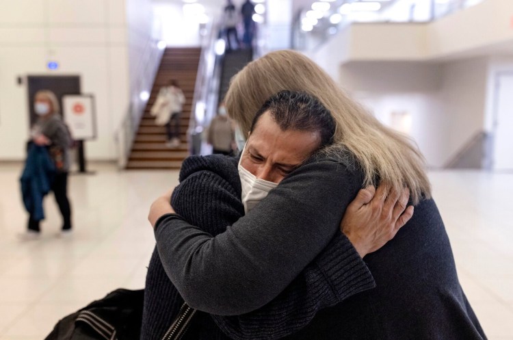 Otto Morales-Caballeros cries as he hugs his wife Sandra Scribner Merlim after being reunited at the Portland Jetport on Sunday, December 5. The two had not seen each other since Merlim’s trip to Guatemala in 2018. Morales-Caballeros was deported in 2017 after 20 years of living and working in the United States. 