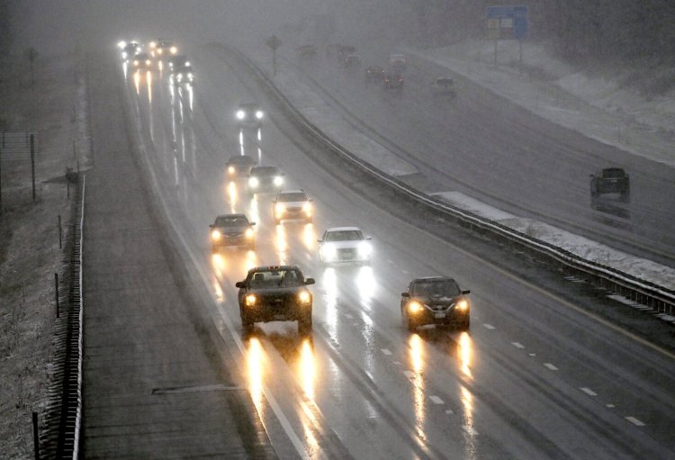 Vehicles move slowly along the Maine Turnpike  as snow begins to fall in Saco on Dec. 18,. AAA Northern New England projected more than 4.5 million people in the region would travel away from home between Dec. 23 and Jan. 2.