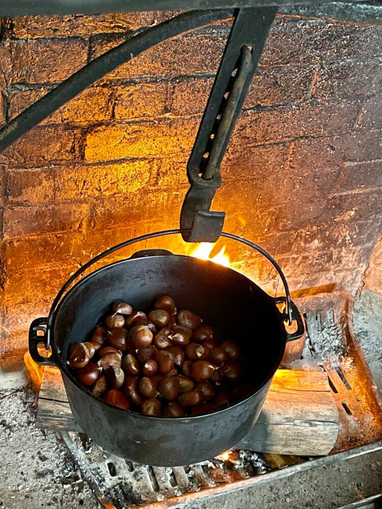 Chestnuts roast over an open fire in the home of columnist Christine Burns Rudalevige. She soaked the chestnuts for 30 minutes in water, cross-hatched them, then roasted them in a borrowed Dutch oven.