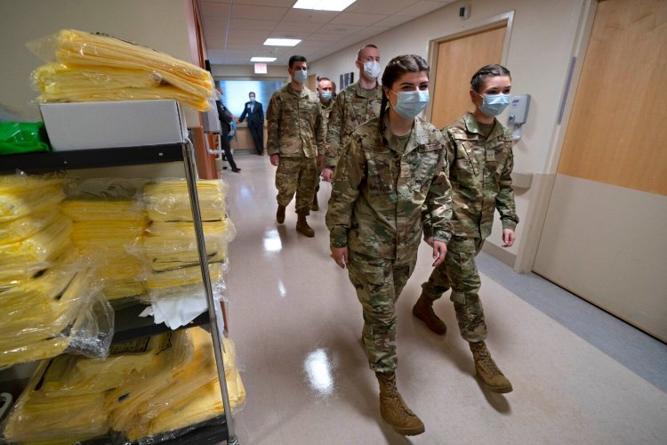 Members of the Maine National Guard arrive for orientation at an empty wing at Central Maine Medical Center in December in Lewiston. 