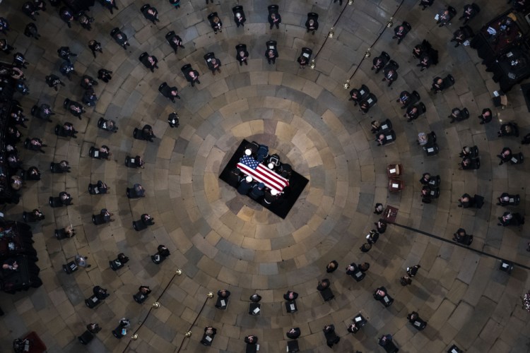 The casket of former Sen. Bob Dole, R-Kan., arrives in the Rotunda of the U.S. Capitol, where he will lie in state, Thursday, Dec. 9, 2021, on Capitol Hill in Washington. 