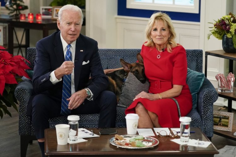 President Biden, first lady Jill Biden and their new dog, Commander, meet virtually with service members around the world on Saturday, in the South Court Auditorium on the White House campus in Washington.