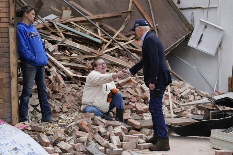 President Biden greets people as he surveys damage from tornadoes and extreme weather in Mayfield, Ky., on Wednesday.


