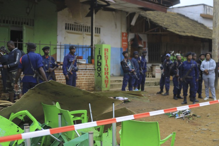 An area is cordoned off as police officers inspect the scene of Saturday's bomb explosion in Beni, eastern Congo, on Sunday.