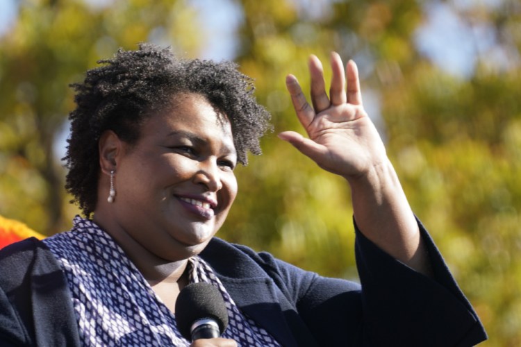 Stacey Abrams speaks to Biden supporters as they wait for former President Barack Obama to arrive and speak at a campaign rally for Biden at Turner Field in Atlanta on Nov. 2, 2020. 