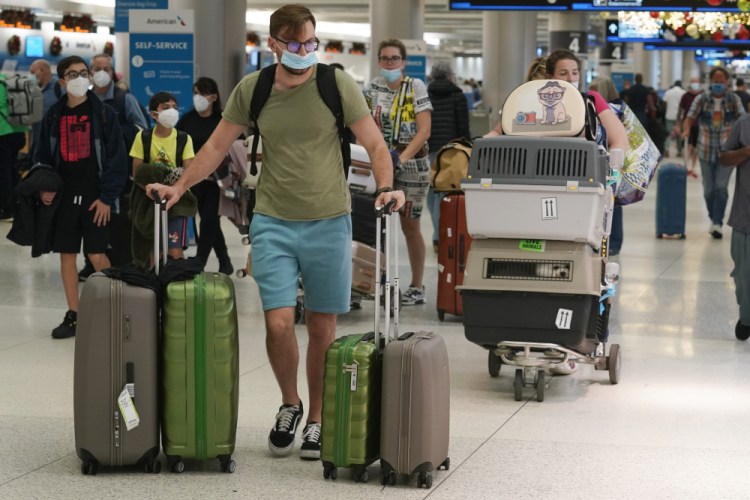 A family and their pets walk through Miami International Airport on Monday. Air travel remains strong, but for how long is just one of dozens of questions experts and officials have no answer for yet.