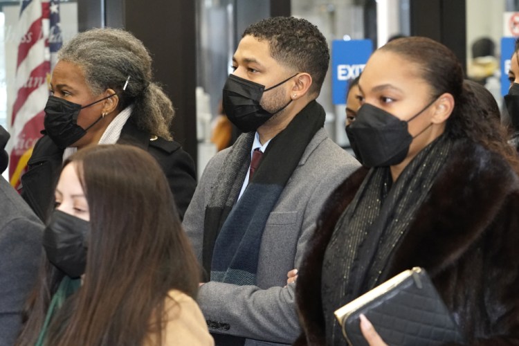 Actor Jussie Smollett, center, arrives with his mother, Janet, left, Monday at the Leighton Criminal Courthouse for day five of his trial in Chicago. 