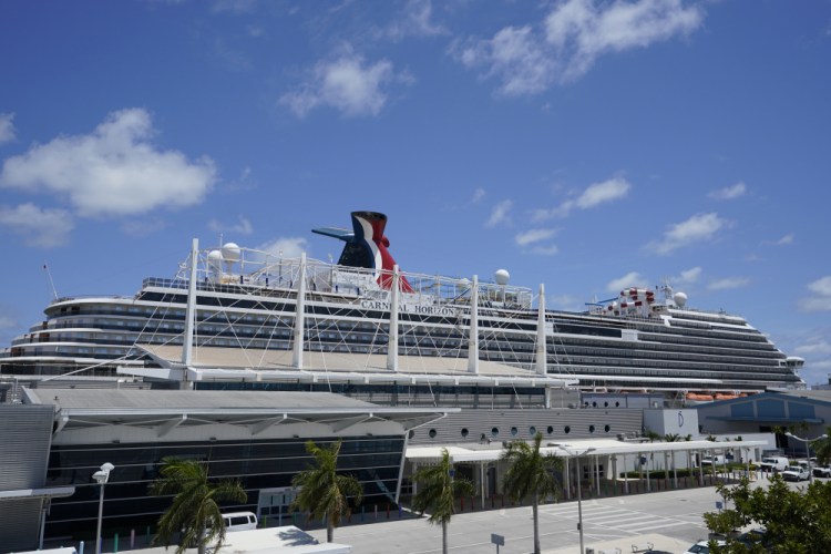Carnival Cruise Line's Carnival Horizon cruise ship is shown docked at PortMiami in April. The U.S. Centers for Disease Control and Prevention is investigating more cruise ships due to new COVID-19 cases aboard.