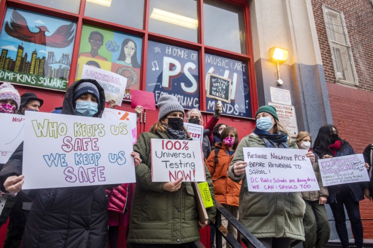 Teachers from the Earth School in New York City demonstrate over lack of COVID testing outside of P.S. 64 on Tuesday. On Monday, a fifth of New York City’s public school students skipped in-person classes.