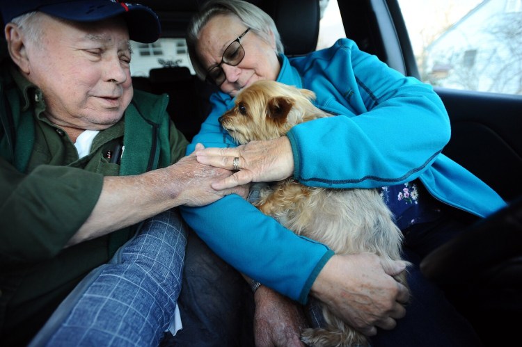 Karen Veilleux, 64, her husband Bob, 80, and their dog Sophie, a 10-year-old Yorkshire Terrier, gather Thursday in the front seat of their Jeep Cherokee where they spent 22 hours while stranded on Interstate 95 in Virginia during a snowstorm earlier in the week. Karen Veilleux said it was Sophie’s first road trip. The couple lives in Oakland.