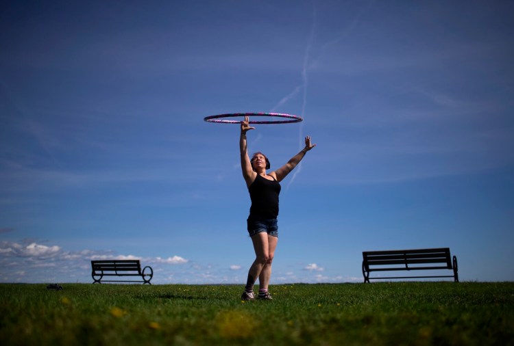 PORTLAND, ME - SEPTEMBER 14: Abbey Schneider of Portland dances with a hula hoop at the Eastern Promenade on Tuesday, Sept. 14, 2021. Abbey said that she grew up with a background in ballet and always had the dream of joining Cirque du Soleil.  (Photo by Derek Davis/Staff Photographer)