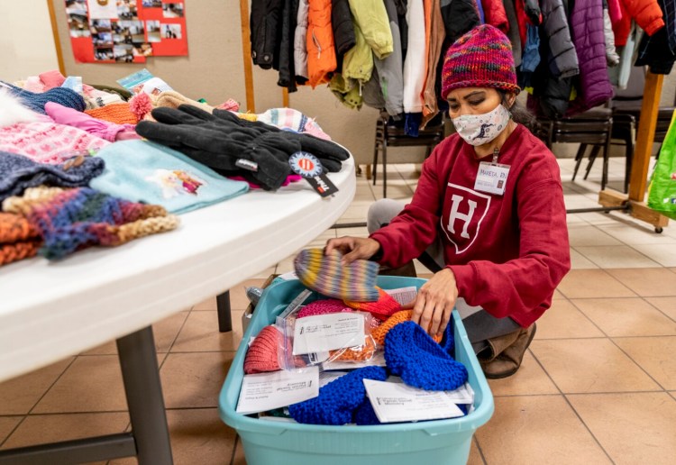 Volunteer Marieta Atienza sorts donated hats during the St Hyacinth's Social Justice and Peace Committee Day of Service at the church in Westbrook on Monday. The event honors Dr. Martin Luther King Jr's birthday and provided food, clothing, health screenings and haircuts.