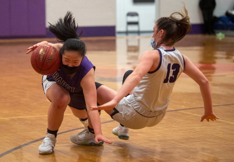 Watervillel’s Dakodah Aldrich (13) fouls John Bapts' Jane Wu (20) during a Jan. 21 girls basketball game in Waterville.