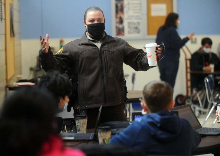 Somerset County sheriff's Deputy Chelsea Merry speaks with students Thursday in the cafeteria at Madison Area Memorial High School. Merry is a school resource officer assigned to the schools in town.