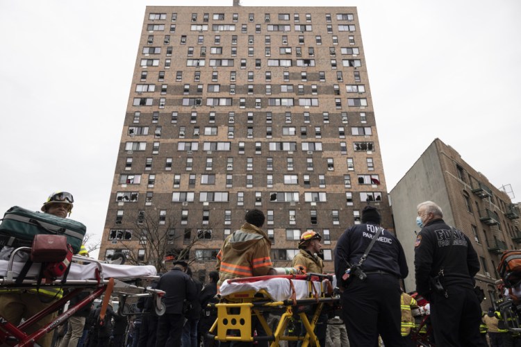 Emergency personnel work at the scene of a fatal fire at an apartment building in the Bronx on Sunday in New York. The majority of victims were suffering from severe smoke inhalation, FDNY Commissioner Daniel Nigro said.